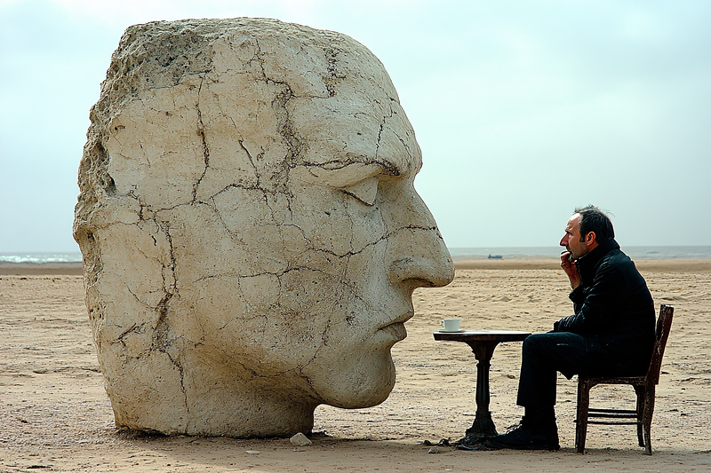 Beachside Contemplation with Stone Head