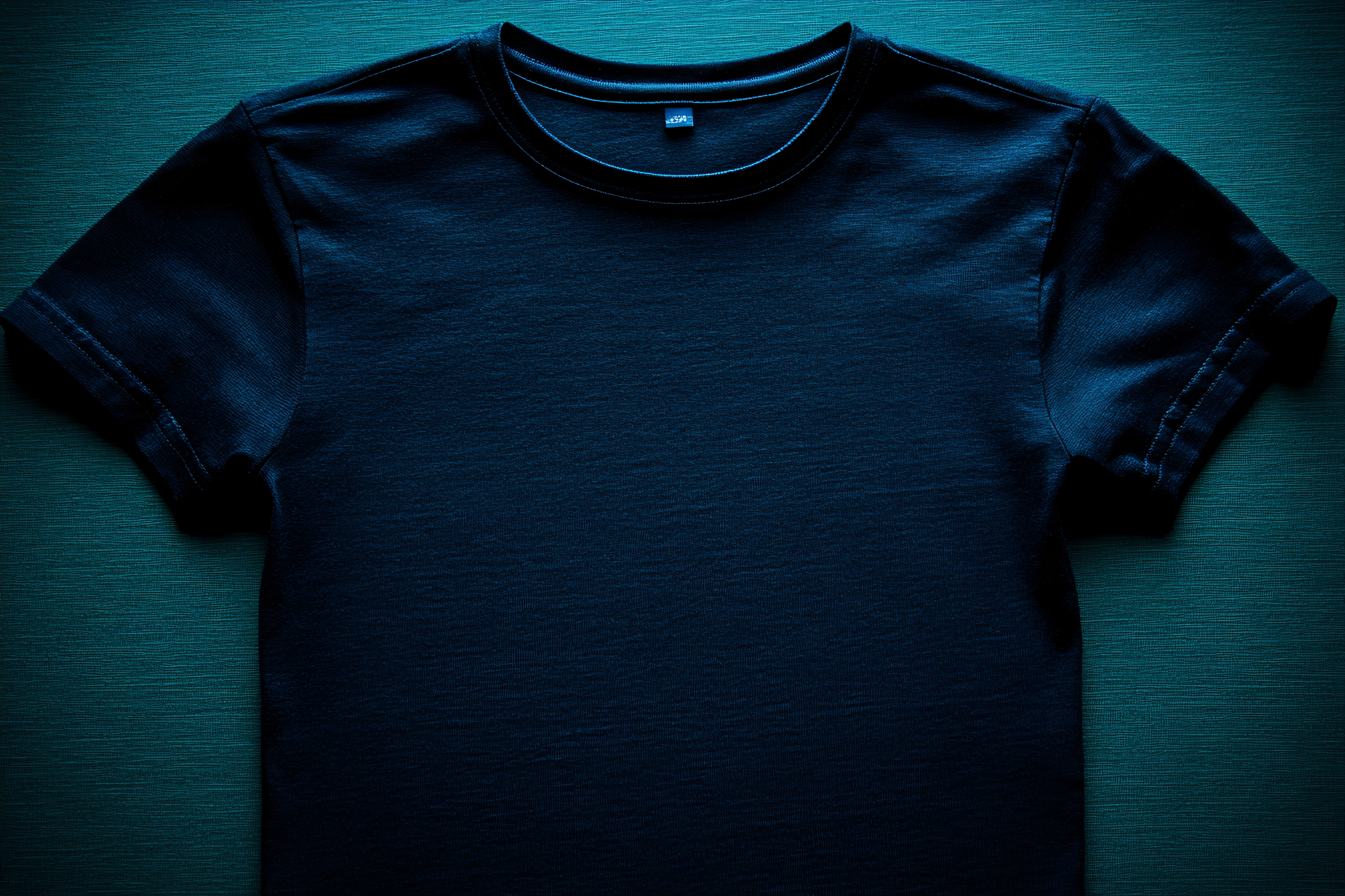 Dark Blue T-Shirt on Green Textured Background