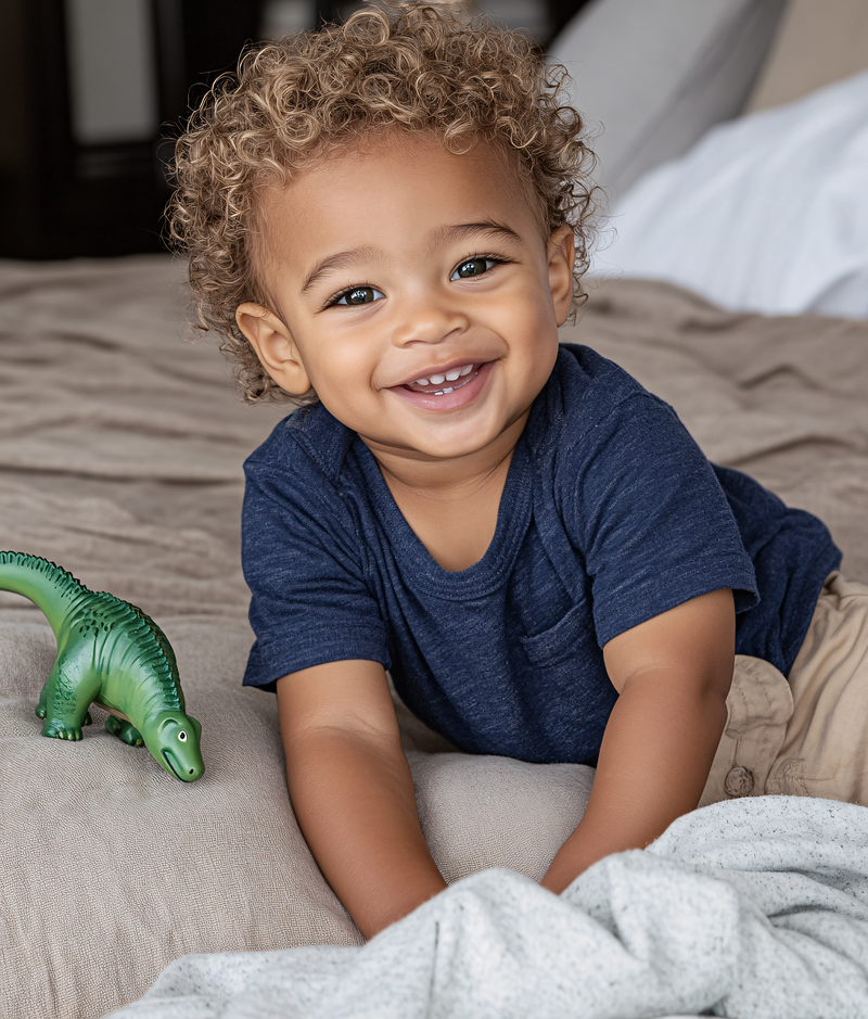 Smiling Baby with Toy Dinosaur
