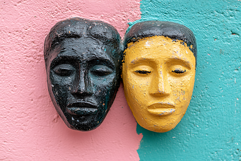 Two Face Masks on Colorful Wall