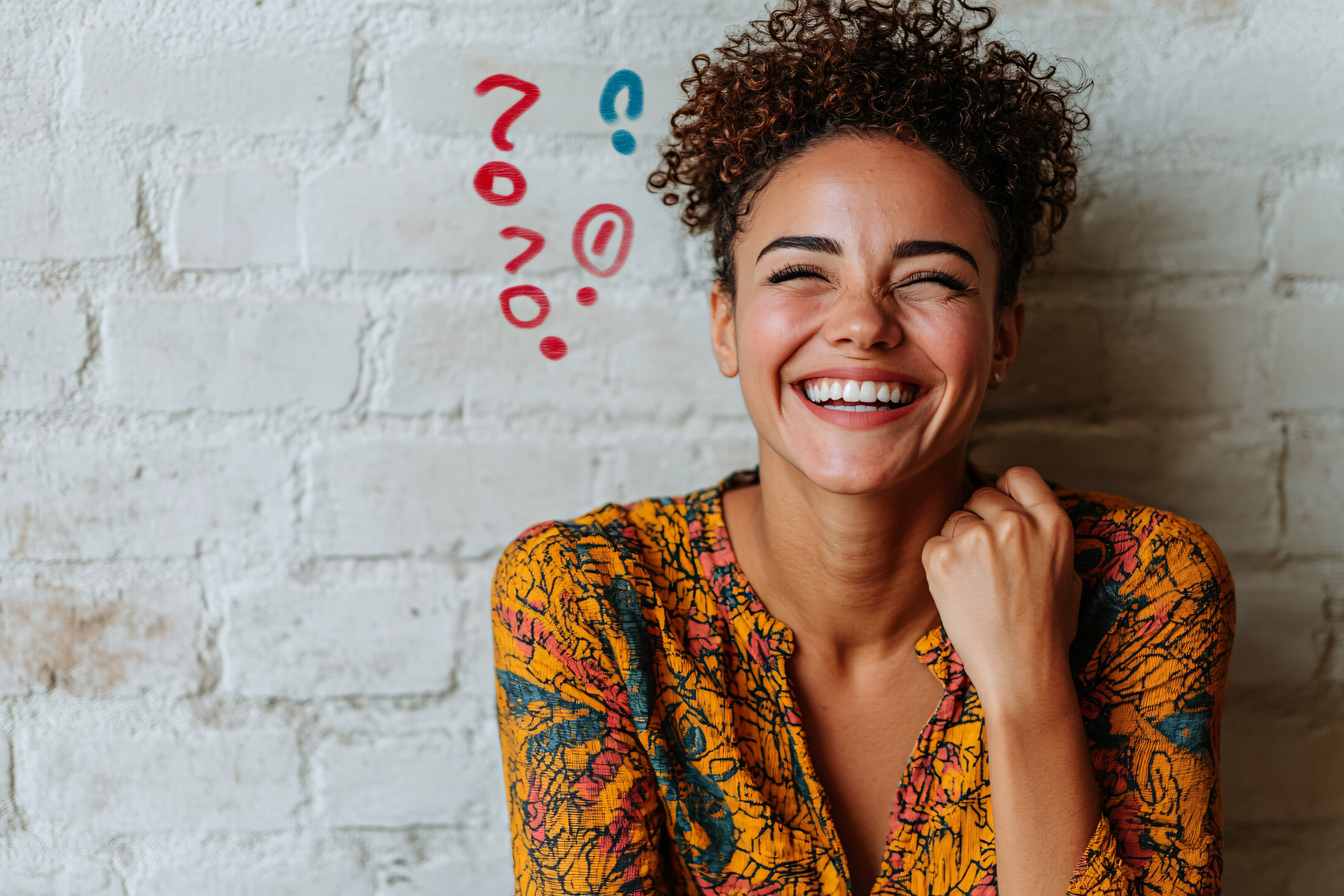 Woman Laughing by a Brick Wall with Question and Exclamation Marks