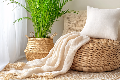 Indoor home decor with green plant, woven basket, pouf and throw blanket